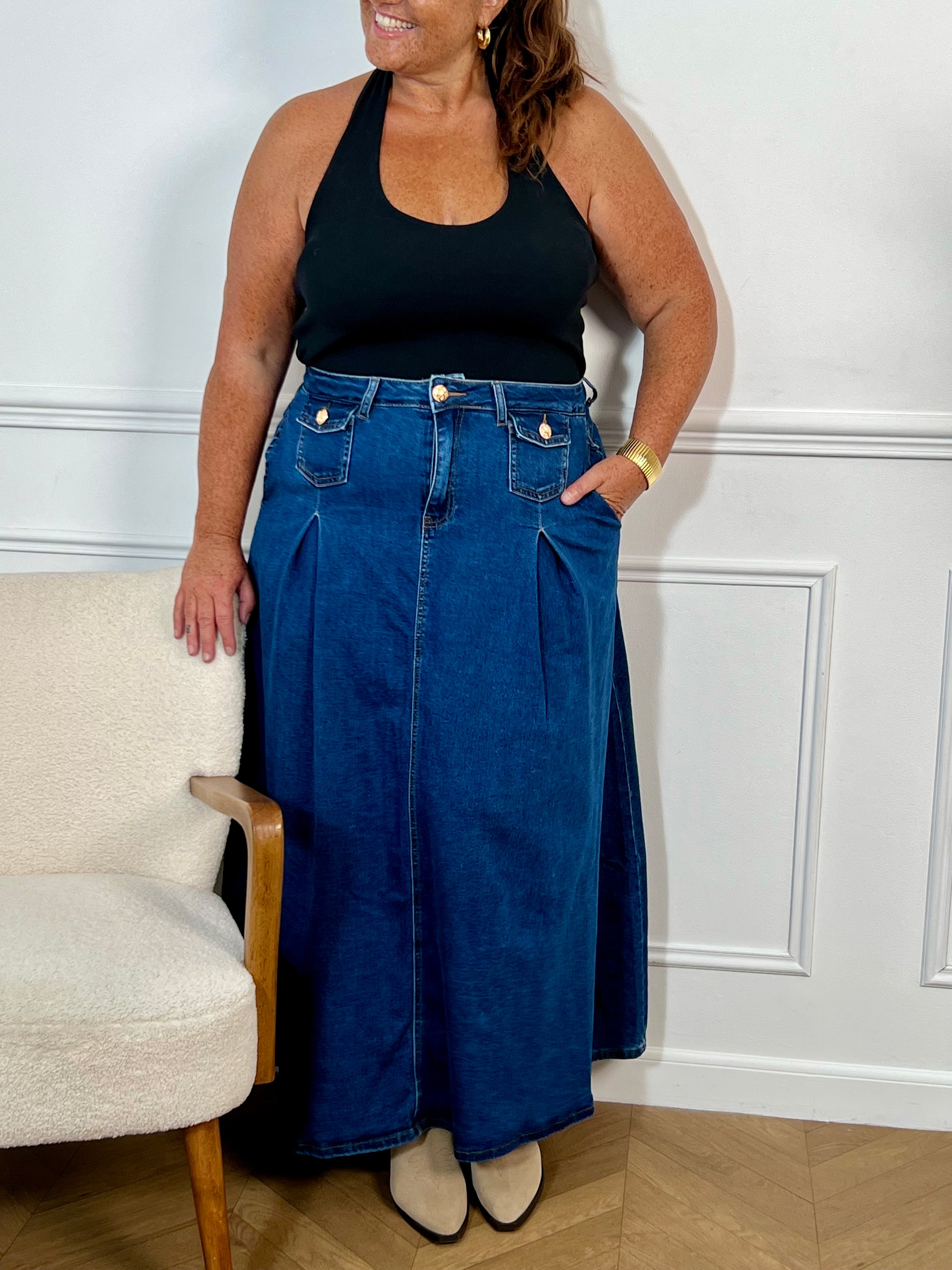 Cette jupe longue en jean bleu foncé pour grande taille offre une coupe évasée confortable. Pratique avec ses multiples poches et ses passants pour ceinture, elle se distingue par ses élégants boutons dorés.