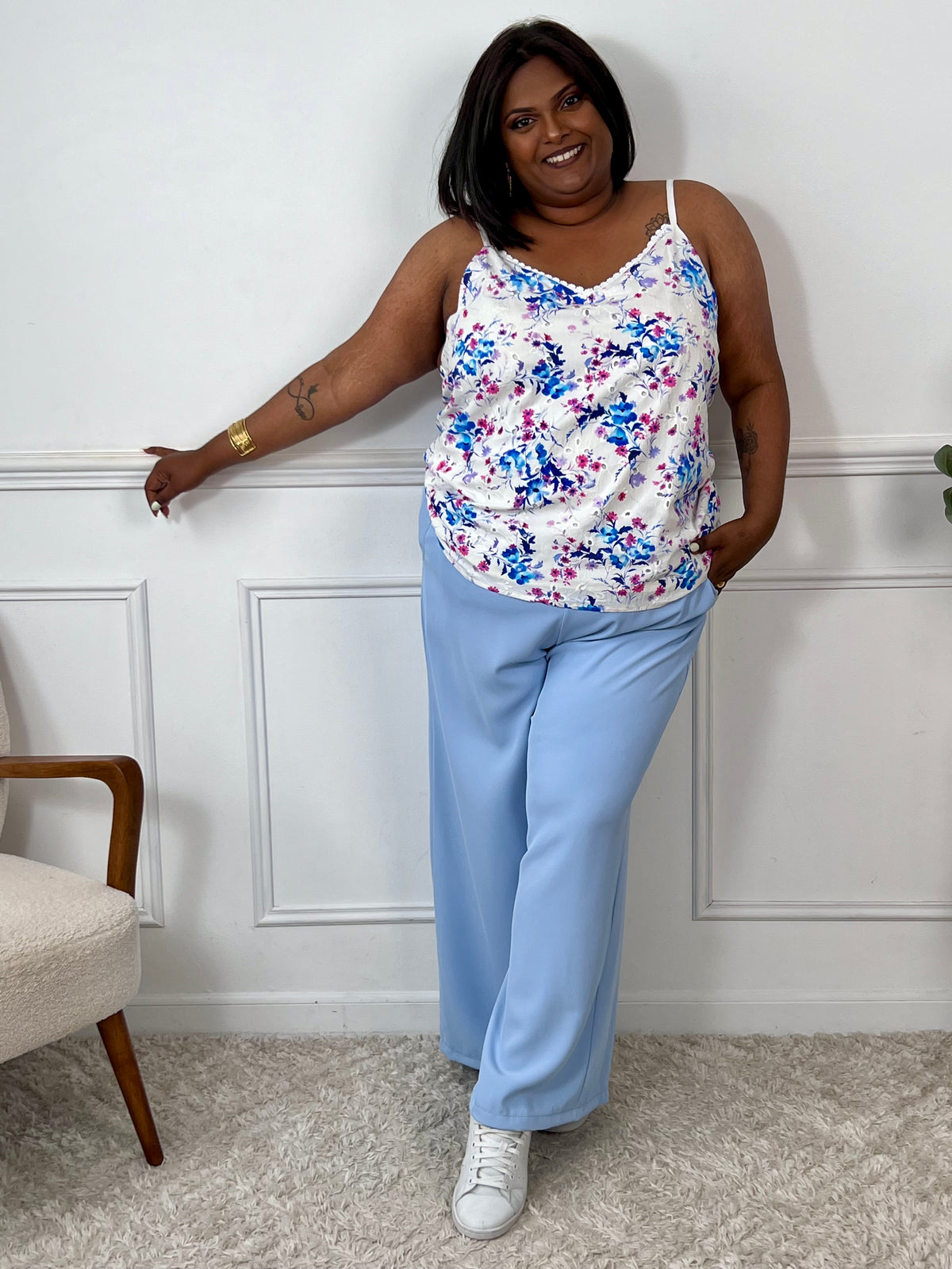 Élégant et confortable, ce top écru Valentina est spécialement conçu pour les silhouettes généreuses. Ses bretelles réglables et sa coupe ample offrent un ajustement parfait, tandis que sa délicate broderie ajourée à motifs floraux en bleu, violet et rose apporte une touche féminine.