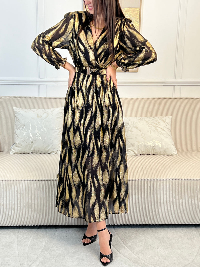 Robe festive Laina, l'allure sophistiquée pour vos soirées. Cette création élégante allie le noir profond et les touches dorées pour une présence rayonnante. Le col cache-cœur flatteuse épouse votre silhouette tandis que la taille élastique offre un confort optimal.