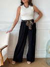 Ce pantalon noir Karoline est un essentiel pour toutes les femmes. Très confortable avec son élastique au dos et ses poches latérales à l'avant, il ajoute une touche de style avec sa ceinture amovible à motifs léopard.