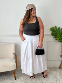 La jupe blanche plissée de grande taille incarne une élégance intemporelle. Avec sa coupe longue, elle offre une silhouette flatteuse et tendance. Cette pièce allie style et confort, créant une tenue sophistiquée et moderne pour les femmes de grande taille.