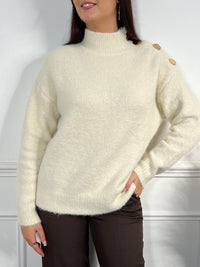 Pull écru avec boutons dorés femme
Manches longues
Col montant
Boutons dorés sur l'épaule gauche
Couleur : écru
