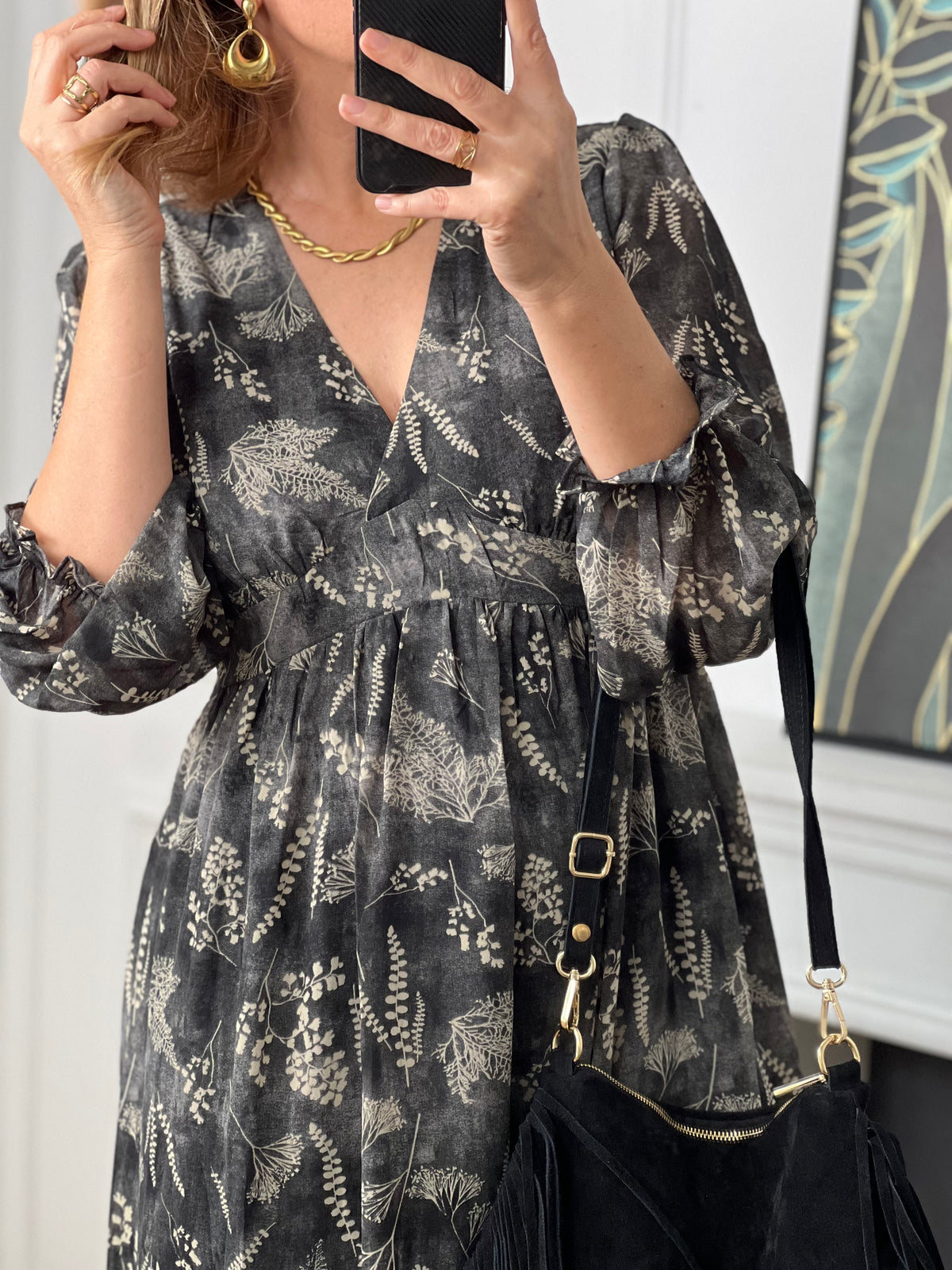 Cette robe longue grise Maeline combine élégance et confort. Ses motifs délicats apportent une touche de féminité, tandis que les manches longues avec volants ajoutent du charme et de la douceur.