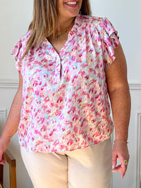 Découvrez notre Blouse colorée Curve : Artie ! Avec ses motifs éclatants et son col V orné de volants, cette blouse apporte une touche de fantaisie à votre garde-robe. Les volants aux épaules ajoutent une allure féminine. Laissez-vous séduire par cette pièce unique qui fera tourner les têtes !