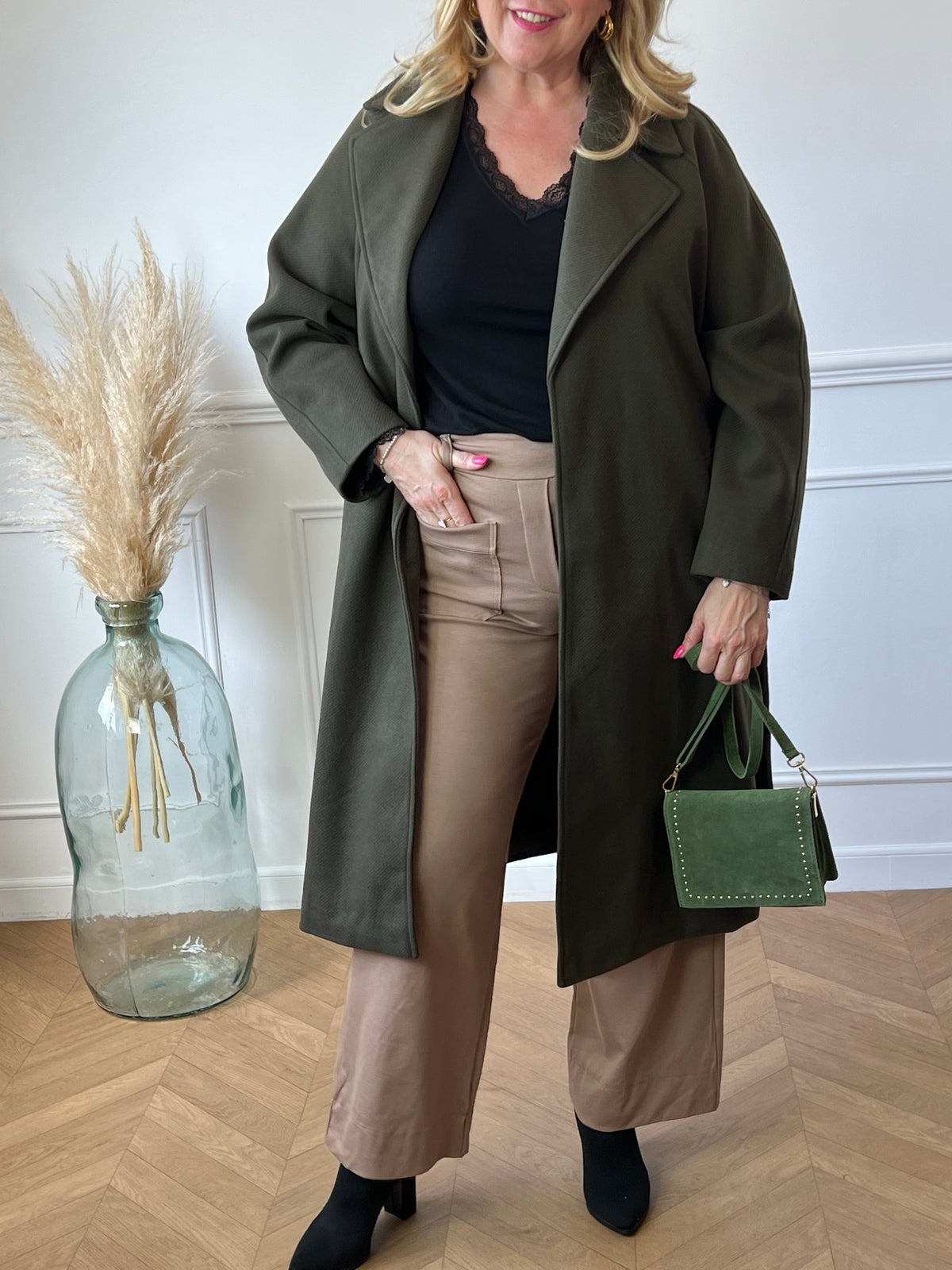 Donnez à votre garde-robe une touche de sophistication avec le manteau long kaki Edia. Doté de manches longues et d'une fente à l'arrière, il allie élégance et confort. Les 2 poches latérales pratiques à l'avant et la ceinture amovible ajoutent une touche pratique à ce manteau chic.