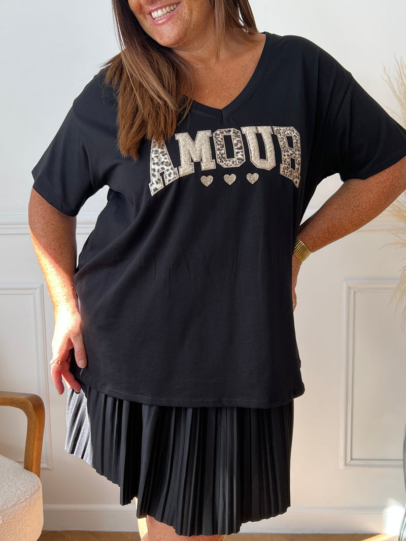 Adoptez le confort avec ce tee-shirt grande taille noir, orné d’une inscription "Amour". Ses manches courtes et son col rond offrent une coupe agréable qui s’adapte parfaitement à votre silhouette.