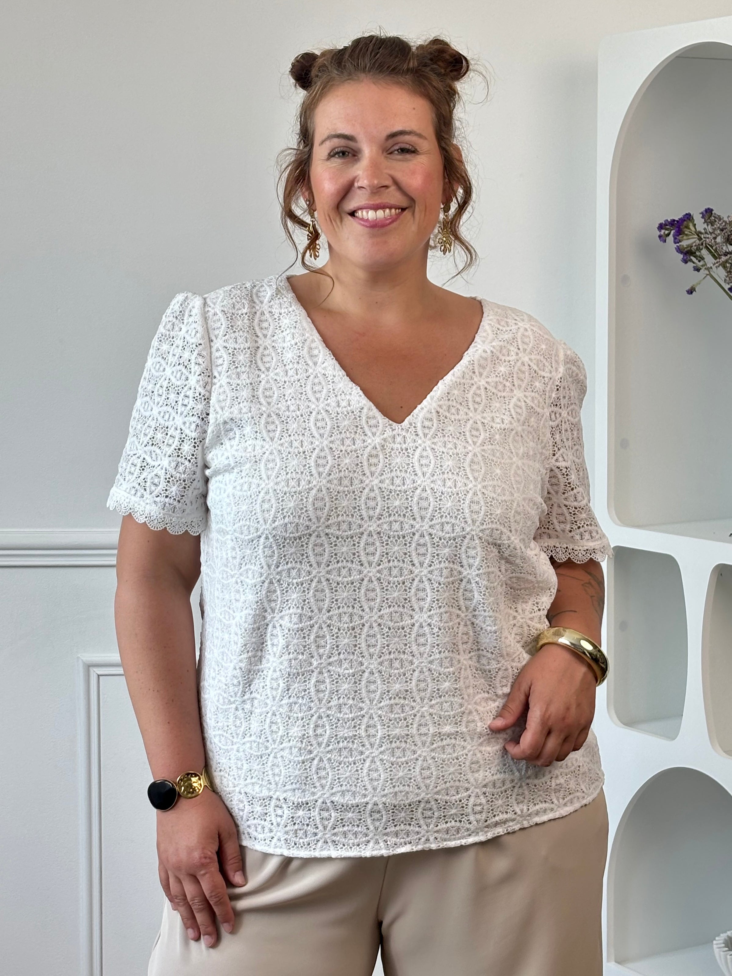 Apportez une touche de douceur et d'élégance à votre dressing avec cette blouse écrue grande taille femme. Son col V et ses manches courtes offrent une coupe féminine et confortable, idéale pour la belle saison. Délicatement brodée, elle se distingue par son dos ajouré qui apporte une note raffinée et tendance. Doublée sur le devant pour plus de confort, cette blouse écrue est parfaite pour composer des tenues chic et légères au quotidien.