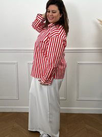 Découvrez Kaely, la chemise parfaite pour affirmer votre style avec assurance. Ses rayures verticales rouge et écru créent une ligne flatteuse qui met en valeur votre silhouette. Réalisée en coton de qualité, elle garantit confort et durabilité tout au long de la journée. Le col chemise intemporel, les manches longues et la rangée de boutons complète offrent une allure soignée et professionnelle.