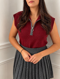 Red sleeveless sweater: Mariel
