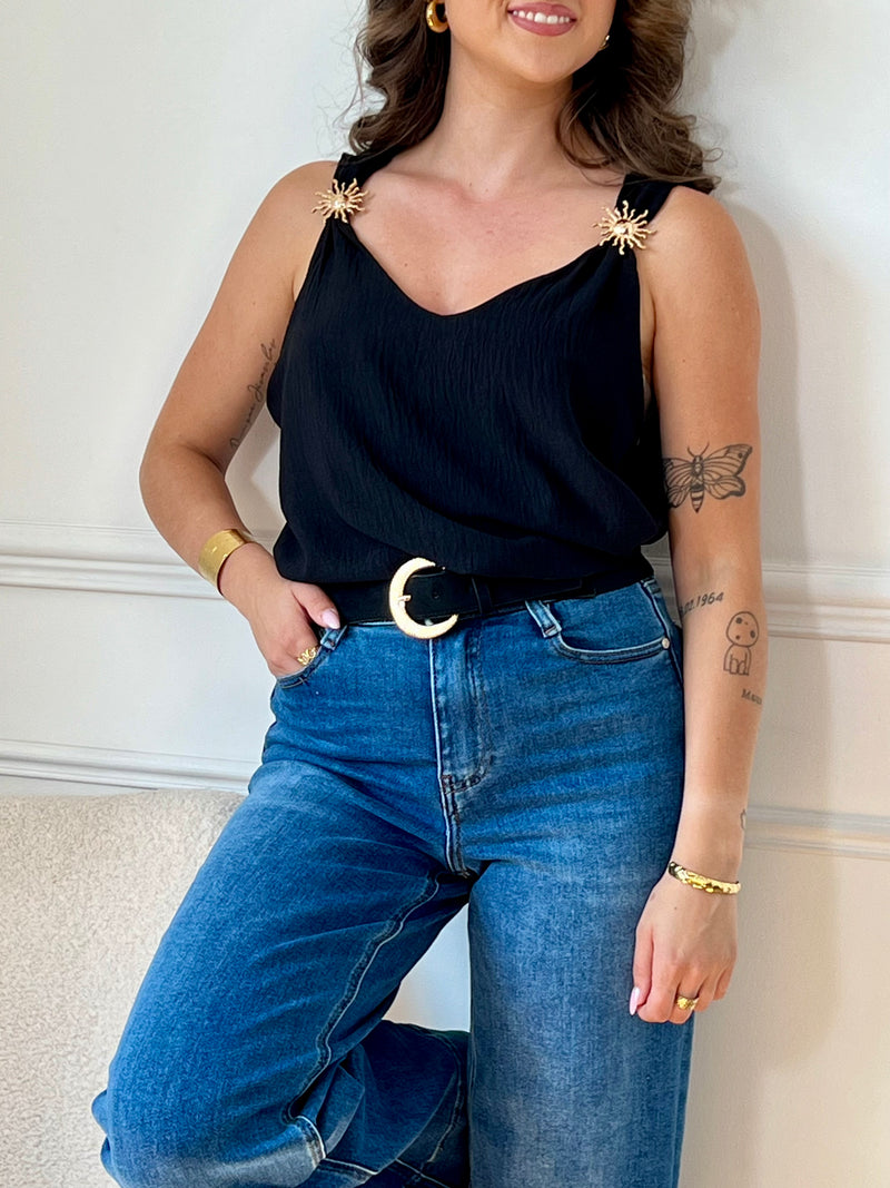 Ce top noir au design épuré séduit par ses bretelles ornées de délicats détails dorés. À la fois sobre et raffiné, il apporte une touche d’élégance à vos looks, de jour comme de nuit.