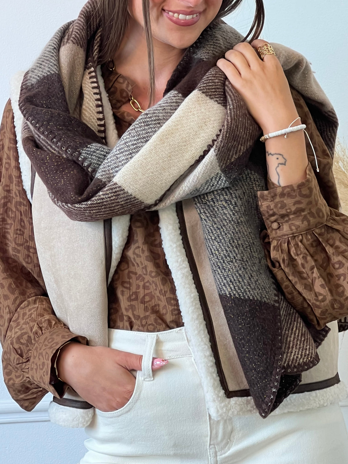 Ajoutez une touche élégante à votre tenue avec notre écharpe Lounia en nuances de marron, gris et beige, agrémentée d'un fil lurex doré pour une touche de brillance. Fabriquée en tissu doux, elle vous gardera au chaud tout en vous offrant confort et style.