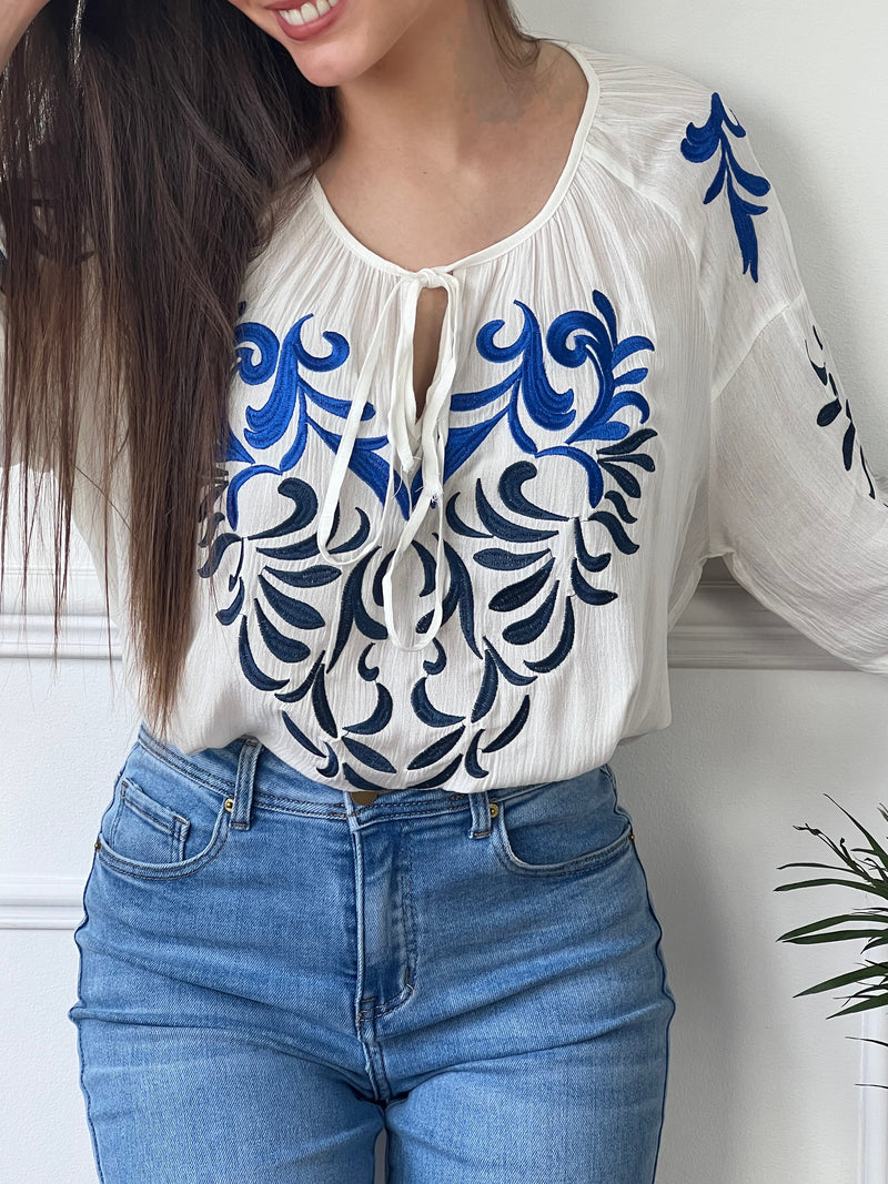 Découvrez notre blouse écrue Carolina ! Avec ses motifs brodés bleus, cette blouse ajoute une touche élégante à votre tenue. Le tissu est doux et confortable, tandis que les motifs brodés apportent une touche de fantaisie. Vous êtes sûr de vous démarquer avec cette blouse unique !