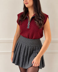 Red sleeveless sweater: Mariel