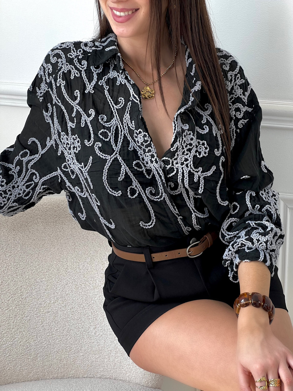 Enveloppez-vous dans l'élégance avec notre chemise noire Taia en gaze de coton. Les manches longues et le col chemise ajoutent une touche classique, tandis que les boutons sur le devant permettent une tenue facile et ajustable.