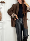 Chic et raffiné, ce blazer marron glacé séduit par ses finitions élégantes. Le détail qui fait toute la différence : des poignets réversibles à motifs léopard et de fines fentes, pour une touche originale et sophistiquée qui sublime la silhouette.