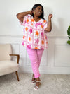 Blouse grande taille en gaze de coton ajourée, col V et manches courtes. Motifs coquillage et soleil en écru, orange et violet pour un look audacieux et frais.