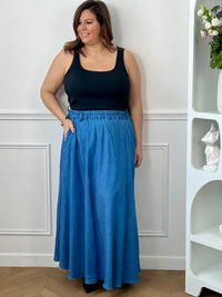 Jupe longue grande taille femme, évasée et fluide, idéale pour un look élégant et confortable. Dotée d’une taille élastique, de deux poches latérales et de passants pour ceinture, elle allie praticité et féminité. Sa coupe ample met en valeur la silhouette tout en offrant une grande liberté de mouvement. En coloris bleu, cette jupe longue est parfaite pour une tenue chic et décontractée au quotidien.