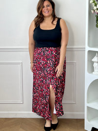 Jupe fleurie noire, rose et rouge à la coupe fluide et féminine. Sa taille élastique assure un confort parfait, tandis que la fente à l’avant apporte une touche légère et élégante.