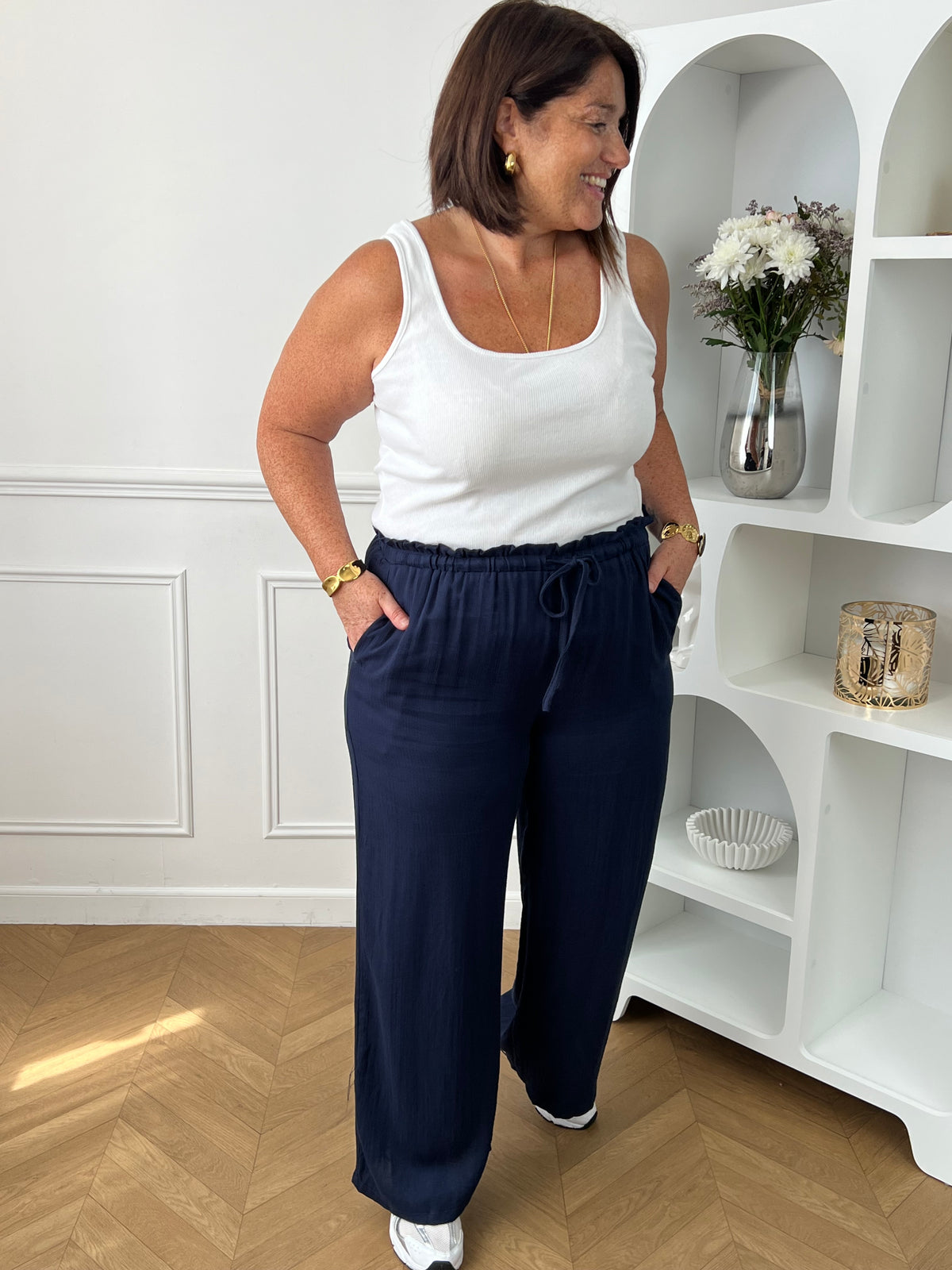 Optez pour ce pantalon élastique grande taille femme à coupe droite, alliant confort et style. Sa taille élastiquée avec lien à nouer assure un ajustement parfait. En bleu marine, il s’adapte facilement à toutes vos tenues du quotidien.