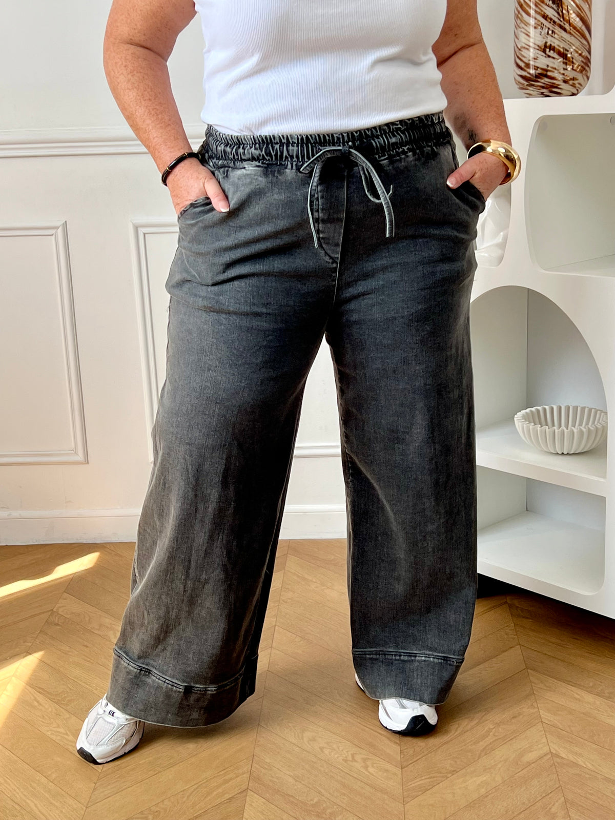Révélez votre élégance avec le pantalon gris foncé Eline grande taille ! Sa coupe droite et taille haute flatte votre silhouette. Pratique avec ses poches avant et arrière, il s'ajuste parfaitement avec son élastique et ses liens de serrage.
