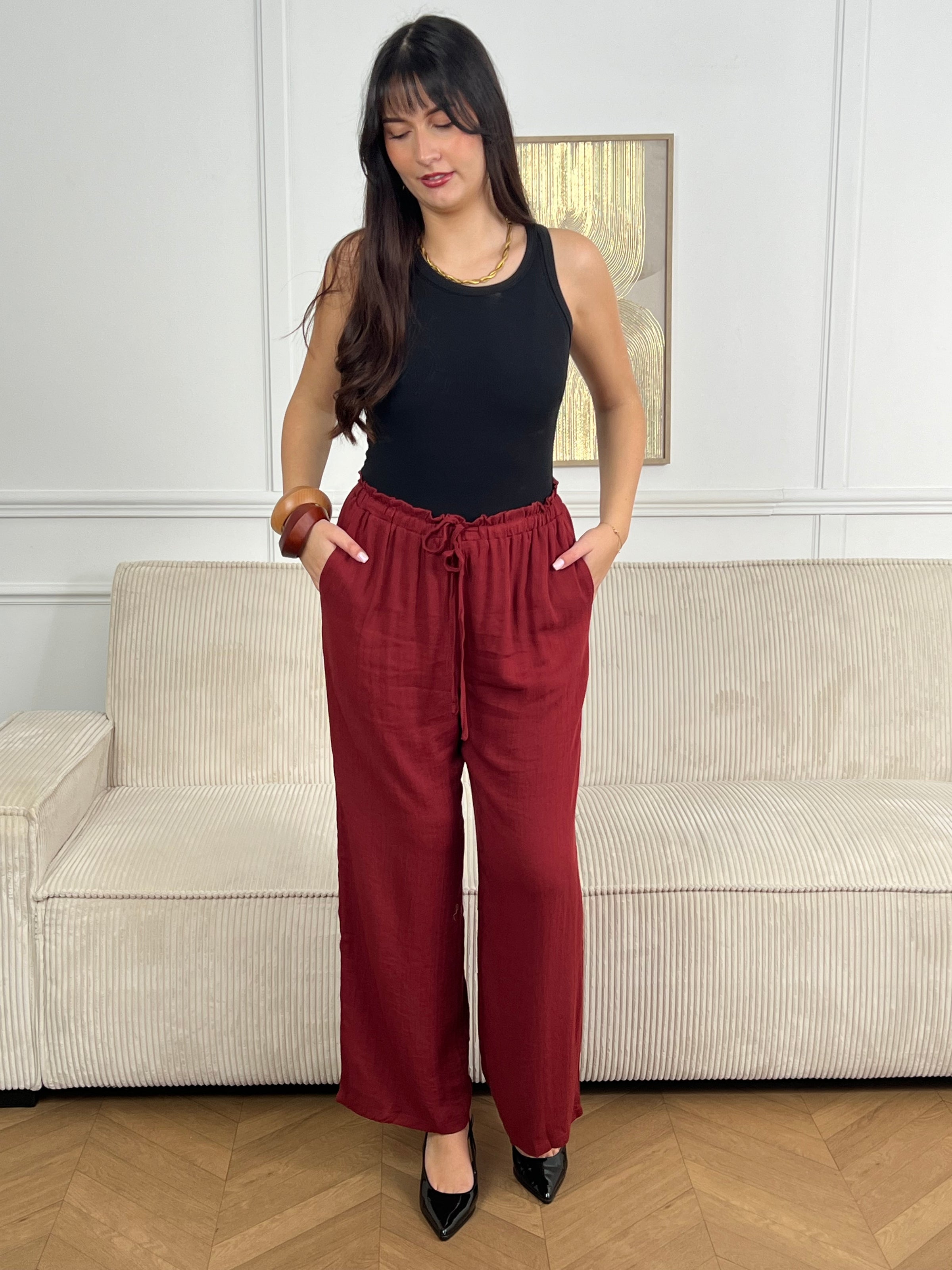 Coupé droit pour une silhouette épurée, il arbore une teinte terracotta chaleureuse qui s'adapte à tous les styles. La taille élastiquée associée à un lien ajustable vous permet de personnaliser votre fit selon vos envies du jour. Parfait pour les moments où vous recherchez une pièce à la fois pratique et élégante, ce pantalon devient rapidement un incontournable de votre garde-robe.