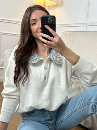 Découvrez le Pull Amelys, une pièce incontournable alliant élégance et confort. Doté d'un col claudine orné de motifs fleuris délicats, ce pull long manches apporte une touche romantique à votre garde-robe. Les boutons à motifs sur le devant ajoutent du caractère et du détail à cette création.