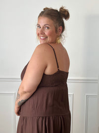Apportez une touche d'élégance à votre garde-robe avec cette robe longue à bretelles femme. Son col V met délicatement la silhouette en valeur, tandis que les bretelles réglables et l'élastique au dos assurent un ajustement confortable et personnalisé. La broche dorée amovible en forme de soleil apporte une finition raffinée et originale, idéale pour sublimer cette robe marron foncé. Une pièce chic et intemporelle, parfaite pour vos journées d'été comme pour vos occasions spéciales.