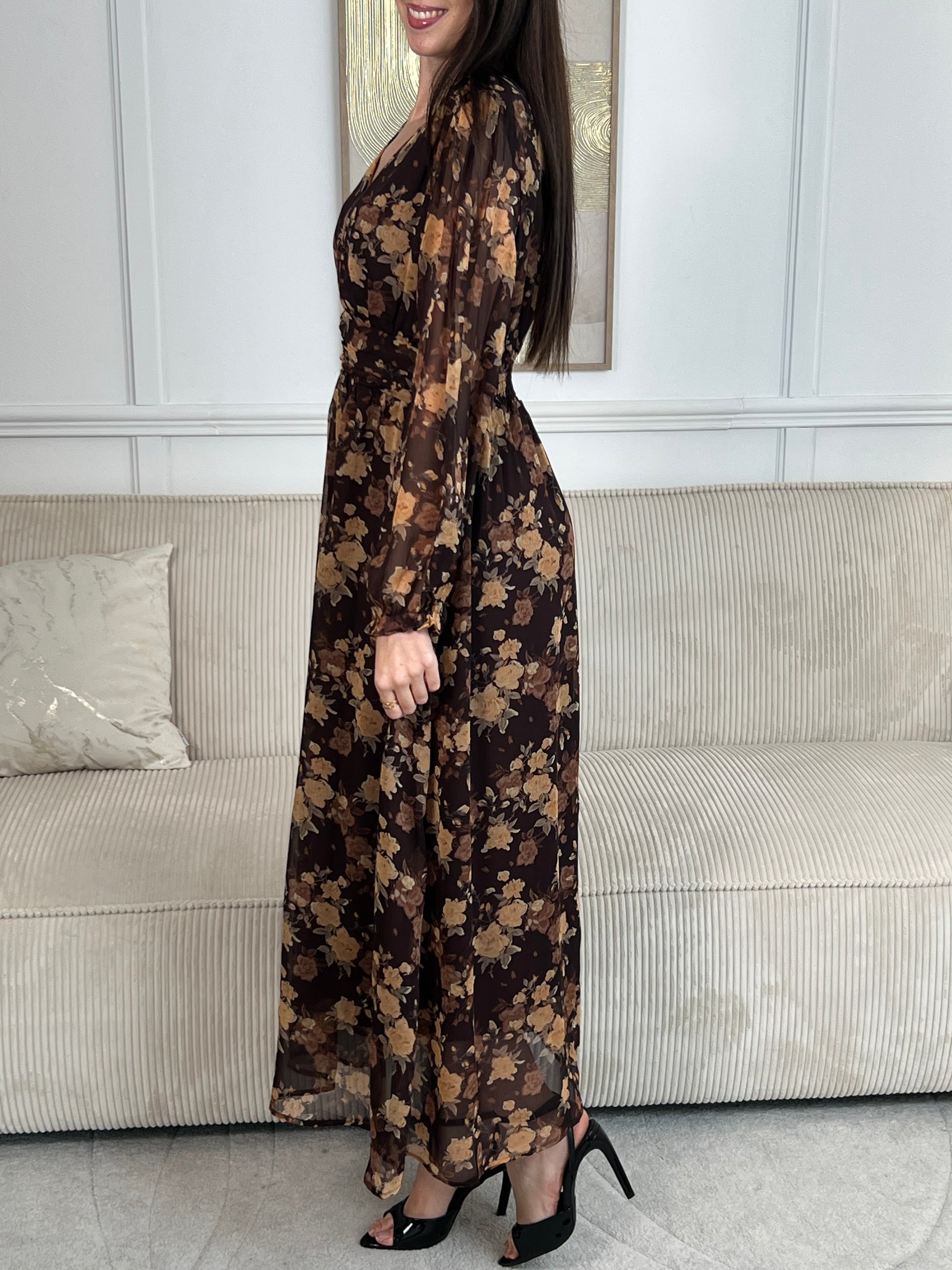 Découvrez la robe longue Eïra, une pièce élégante qui allie style et confort. Confectionnée en marron et noir avec un délicat motif floral, elle séduira les femmes en quête de sophistication. Ses manches longues ornées de volants ajoutent une touche romantique, tandis que le col V affine la silhouette.&nbsp;