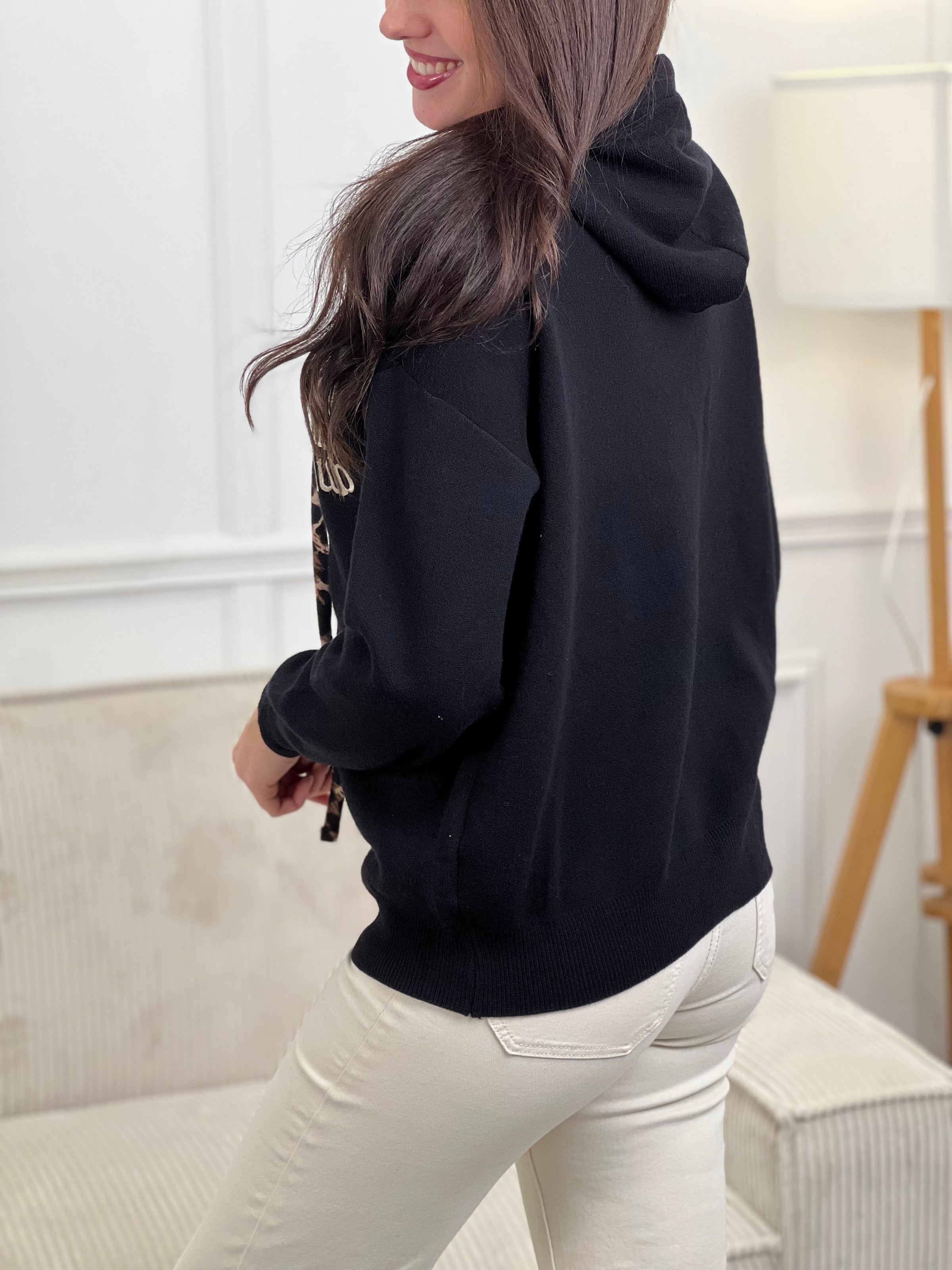 Rejoignez le "Cool mom club" avec notre pull noir à capuche Naelya. Les cordons léopards apportent une touche de style, tandis que l'intérieur léopard de la capuche vous garde au chaud. Les manches longues vous offrent confort et praticité.