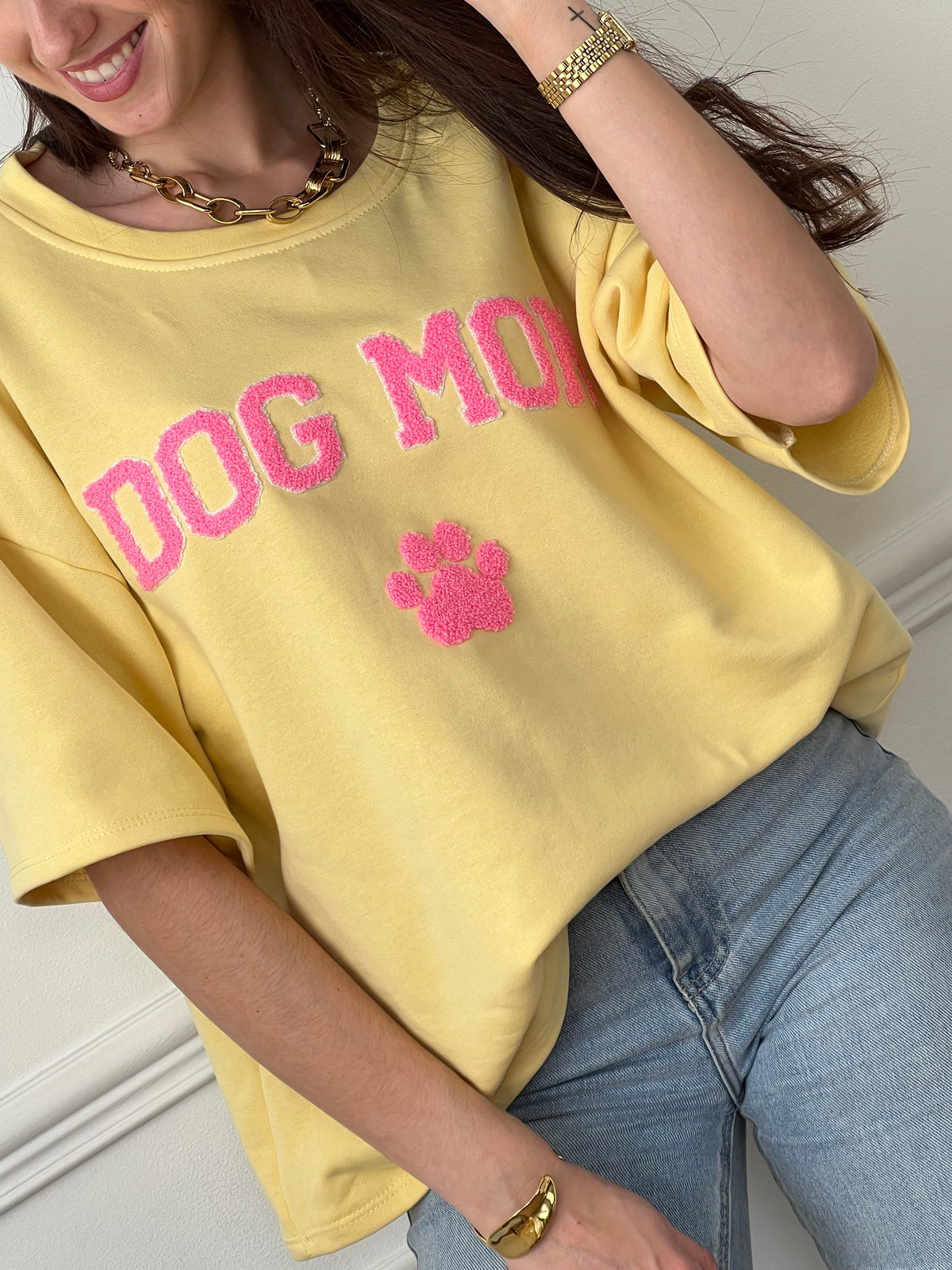 Craquez pour ce tee-shirt style sweat femme, confortable et tendance. Doté de manches courtes et d’un col rond, il est confectionné en 100 % coton pour un confort optimal. Son inscription “Dog mom” en rose et écru avec une patte de chien apporte une touche fun et originale.