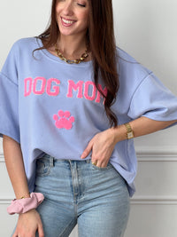 Craquez pour ce tee-shirt style sweat femme, confortable et tendance. Doté de manches courtes et d’un col rond, il est confectionné en 100 % coton pour un confort optimal. Son inscription “Dog mom” en rose et écru avec une patte de chien apporte une touche fun et originale. Ses couleurs bleu, rose et écru en font une pièce facile à porter au quotidien.