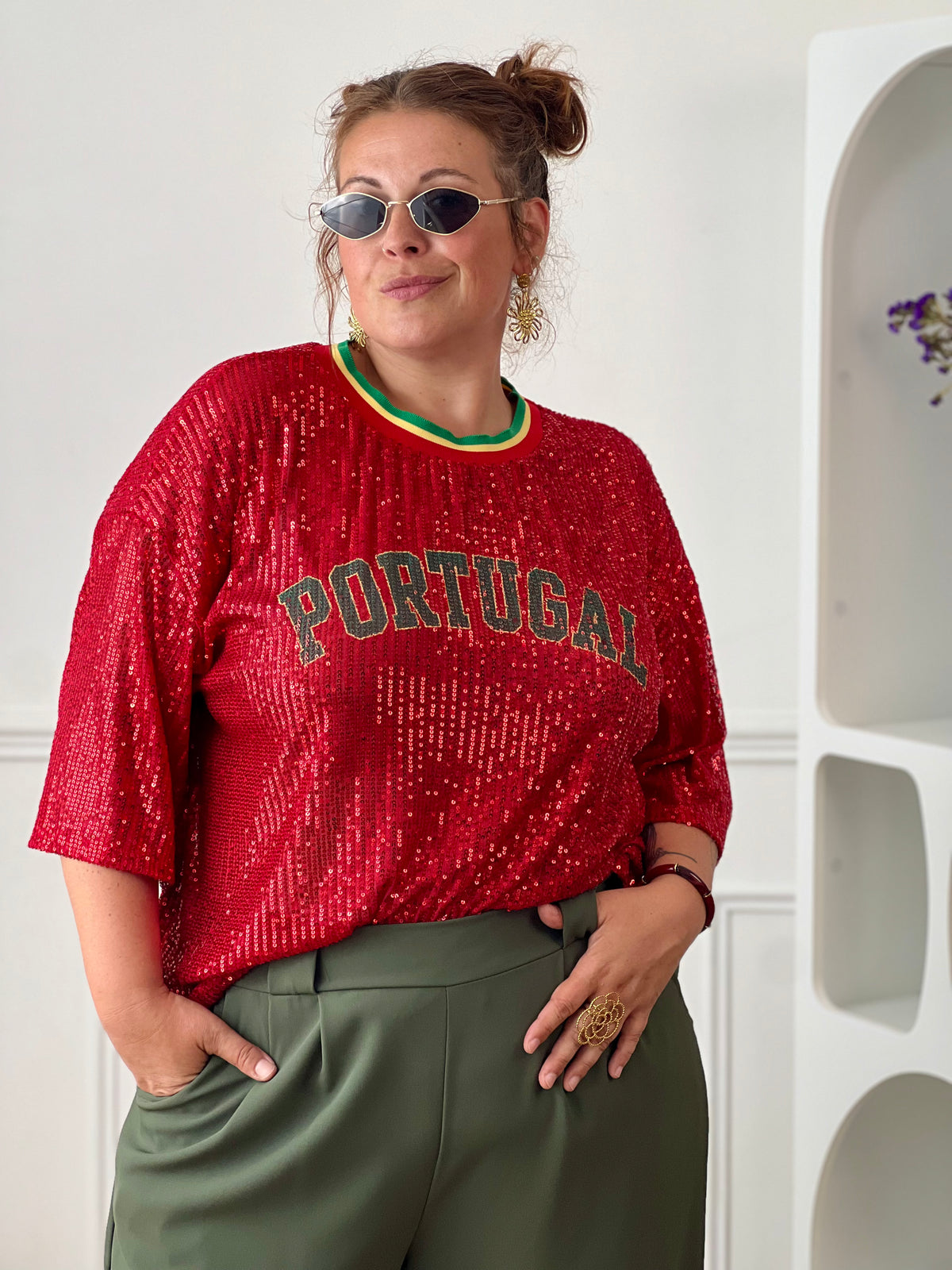 Affichez votre passion avec ce top rouge à sequins grande taille femme, parfait pour un look festif et tendance. Entièrement recouvert de sequins scintillants, il attire tous les regards tout en apportant une touche de glamour. Son col rond en tissu et ses manches courtes offrent un confort optimal, tandis que l’inscription « Portugal » met à l’honneur les couleurs emblématiques rouge, vert et jaune. Une pièce originale et lumineuse, idéale pour soutenir votre équipe ou dynamiser vos tenues.