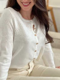 Découvrez le Gilet Davina, une pièce incontournable pour sublimer vos tenues. Confectionné dans une matière fine et délicate, ce gilet écru épouse élégamment votre silhouette. Ses manches longues et ses boutons dorés alignés sur toute la longueur ajoutent une touche de raffinement.